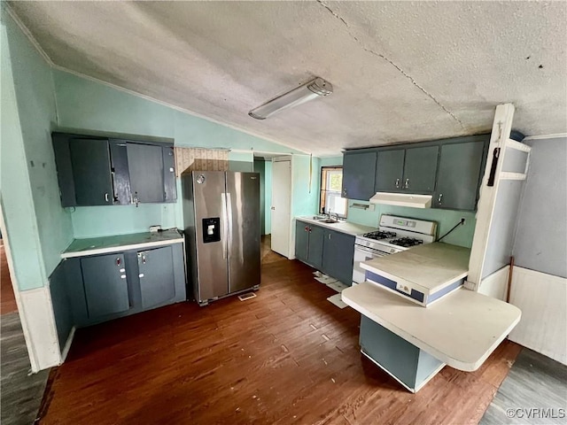 kitchen featuring vaulted ceiling, dark hardwood / wood-style floors, white range with gas cooktop, stainless steel fridge with ice dispenser, and a textured ceiling