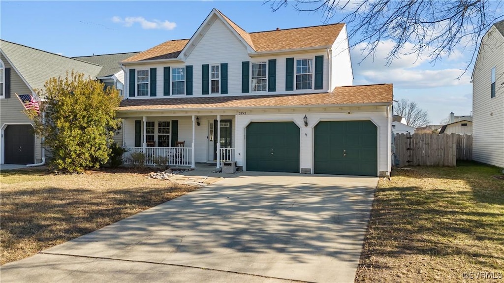 colonial home featuring a garage, a front lawn, and a porch