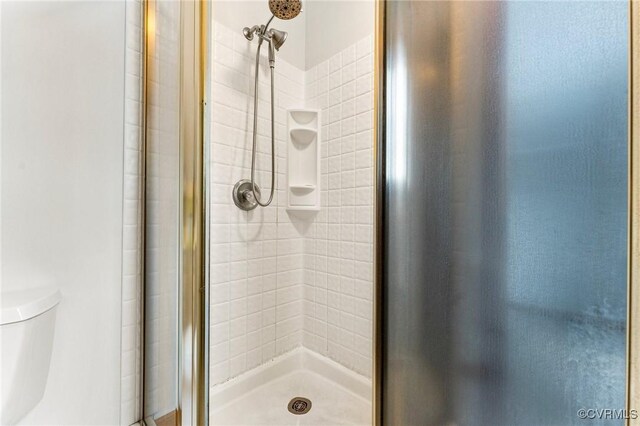 bathroom with toilet and walk in shower