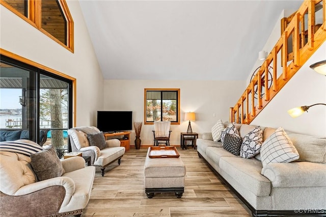 living room featuring light hardwood / wood-style flooring and lofted ceiling