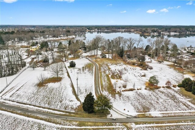 snowy aerial view featuring a water view