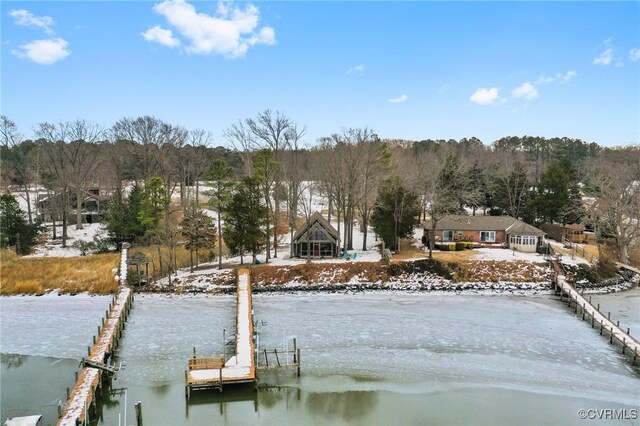 exterior space featuring a dock and a water view