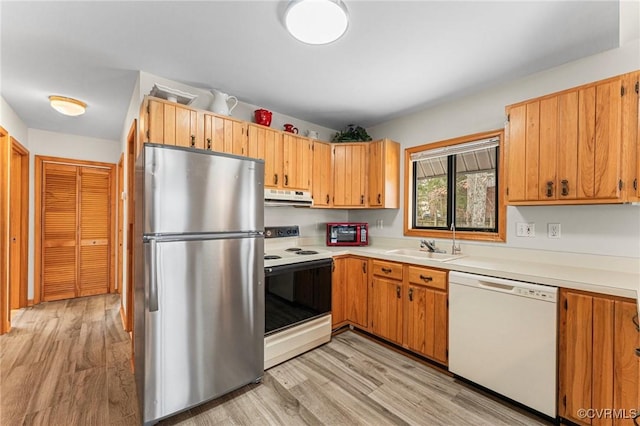 kitchen featuring range with electric cooktop, light wood-type flooring, dishwasher, and stainless steel fridge