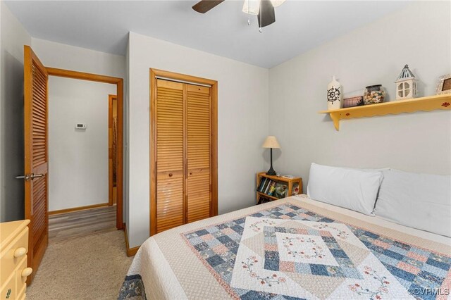 bedroom with light carpet, a closet, and ceiling fan