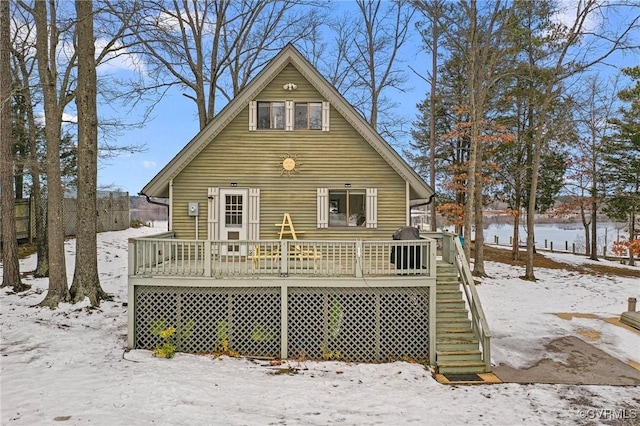 snow covered property featuring stairs and a deck