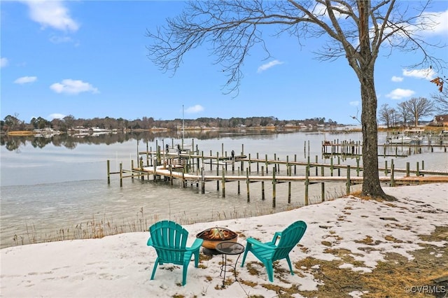 dock area with an outdoor fire pit and a water view