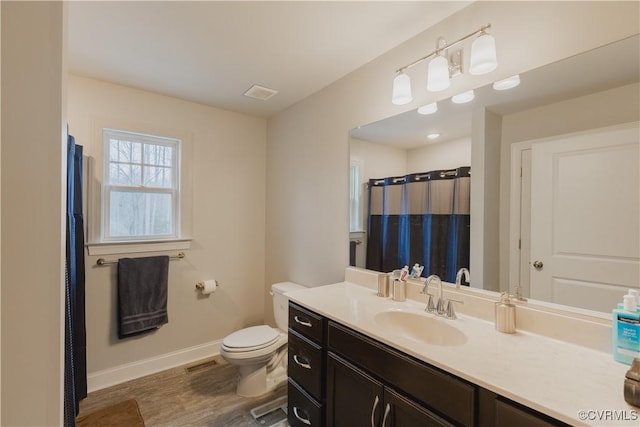 bathroom featuring toilet and vanity