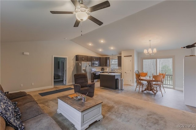 carpeted living room with vaulted ceiling, sink, and ceiling fan with notable chandelier