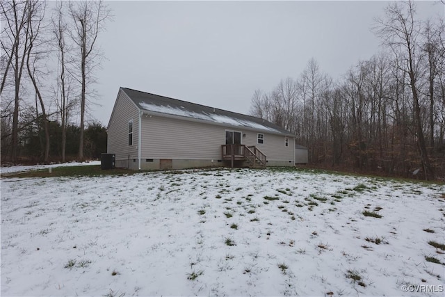 view of snow covered rear of property