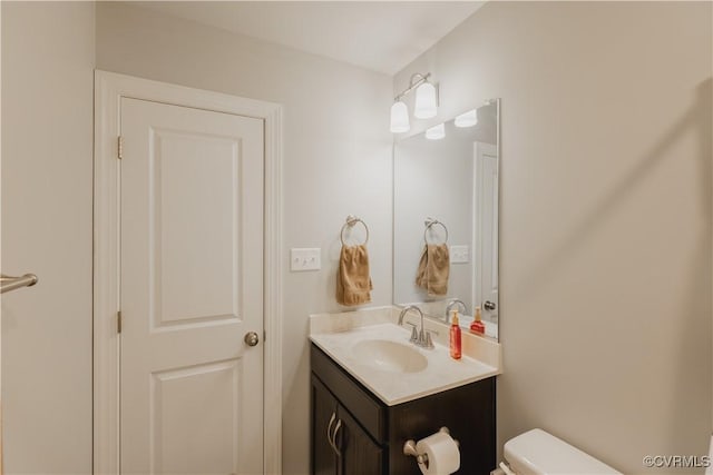 bathroom with toilet and vanity