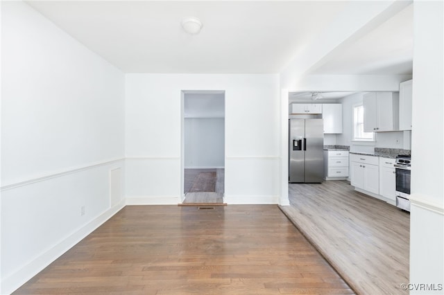 interior space featuring white cabinetry, light hardwood / wood-style flooring, and stainless steel appliances