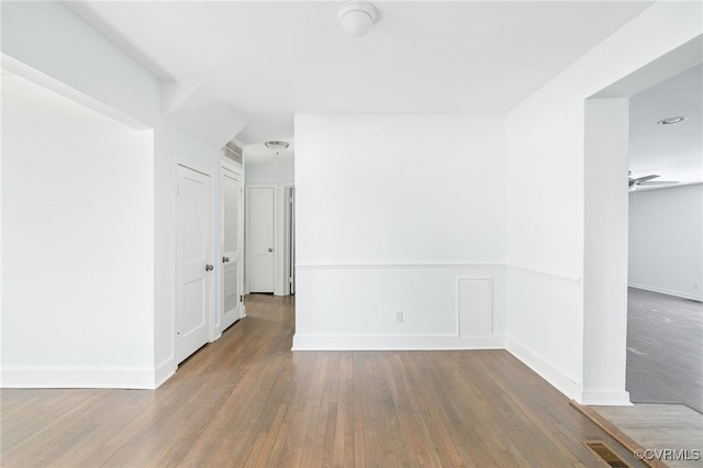 empty room with ceiling fan and hardwood / wood-style floors