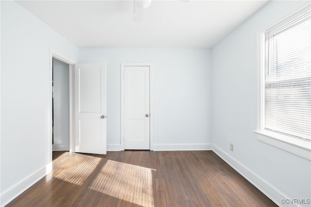 unfurnished bedroom with dark wood-type flooring and ceiling fan