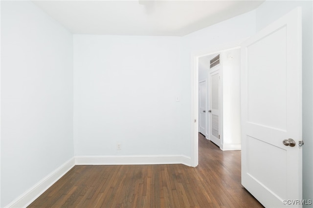 empty room featuring dark wood-type flooring