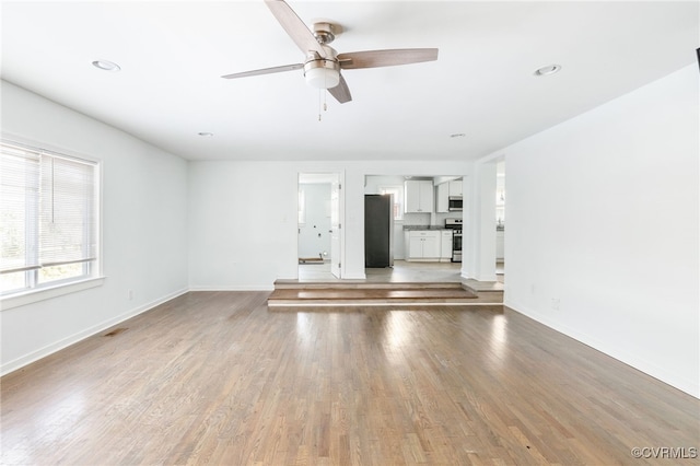 unfurnished living room with hardwood / wood-style floors and ceiling fan