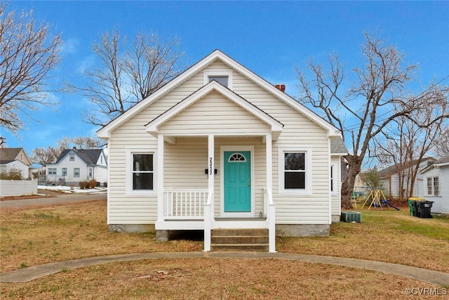 bungalow with a playground and a front yard