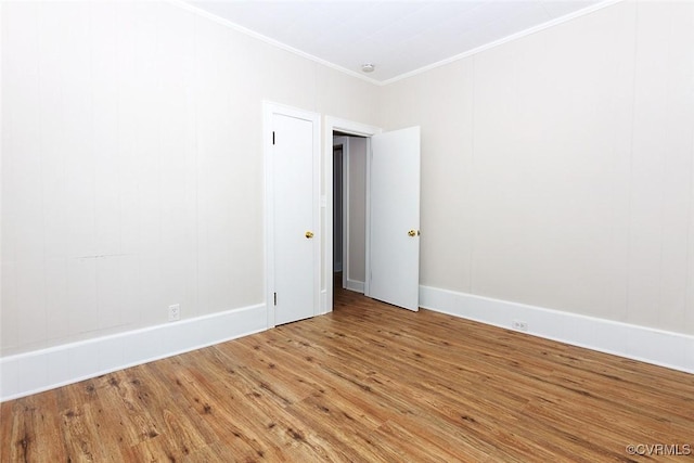 unfurnished room with wood-type flooring and ornamental molding