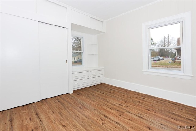 unfurnished bedroom with a closet and light wood-type flooring