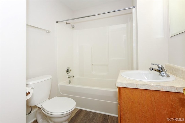 full bathroom featuring toilet, shower / bathtub combination, wood-type flooring, and vanity