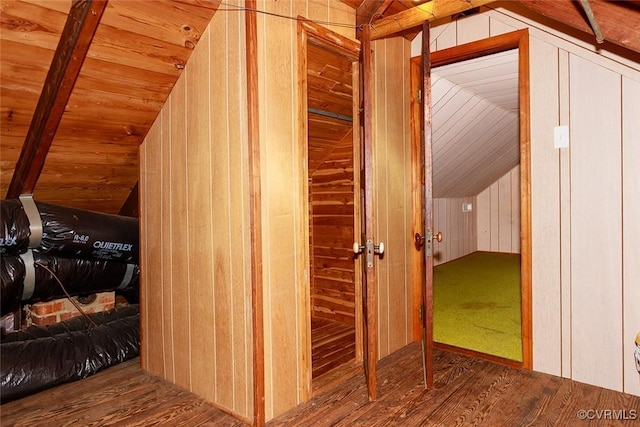 interior space with wooden ceiling, wood-type flooring, lofted ceiling, and wooden walls