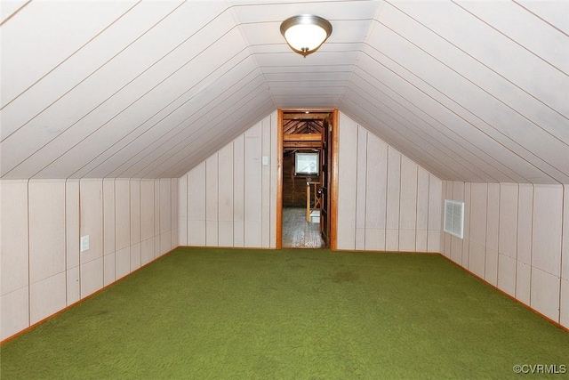 additional living space featuring carpet and lofted ceiling