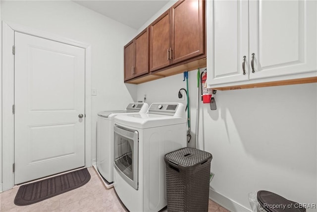 laundry room featuring cabinets and washing machine and dryer