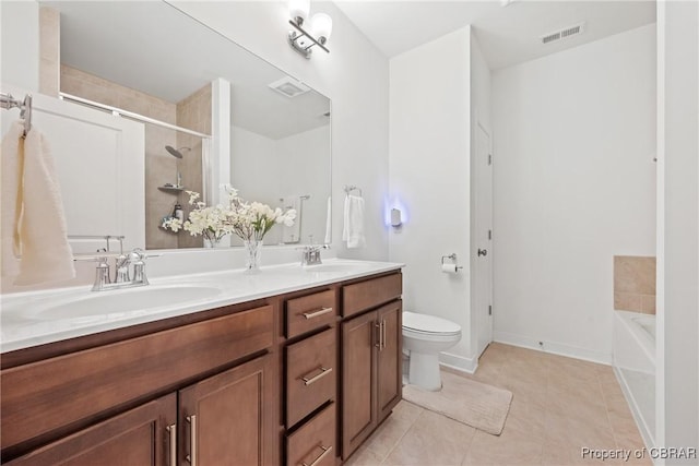 bathroom with toilet, a tub to relax in, tile patterned floors, and vanity