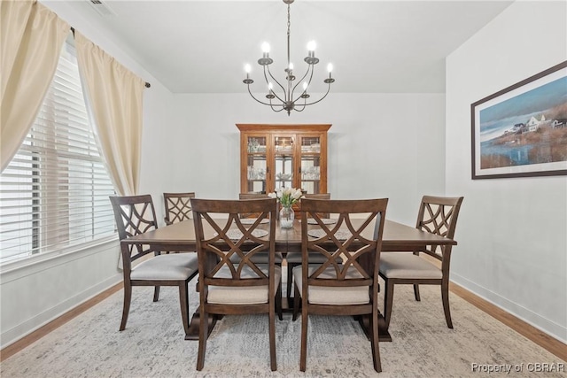 dining space featuring a chandelier and light hardwood / wood-style floors