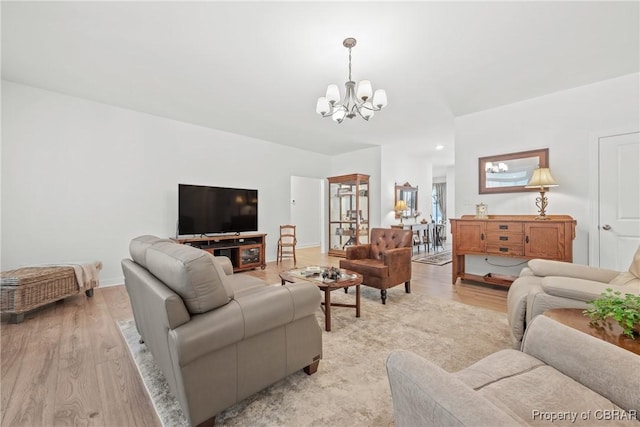 living room featuring light hardwood / wood-style flooring and a notable chandelier