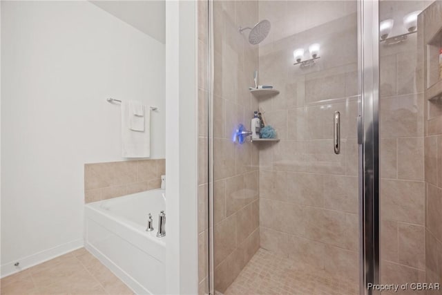 bathroom with tile patterned floors and separate shower and tub