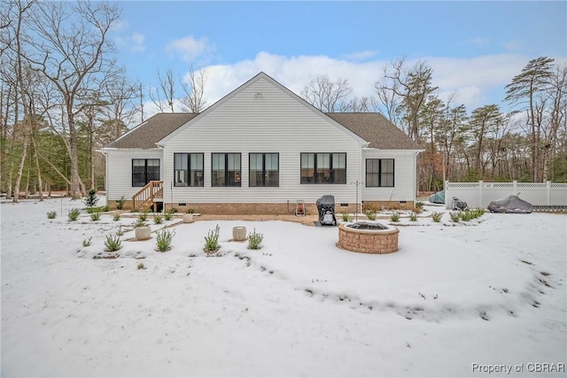 snow covered property with an outdoor fire pit