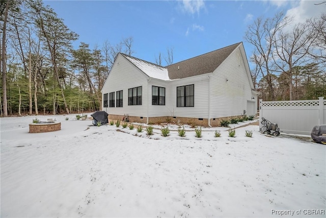 view of snow covered rear of property