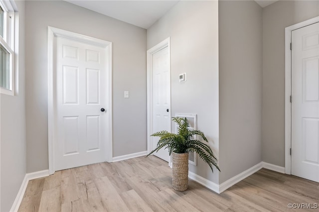 hallway with light hardwood / wood-style flooring