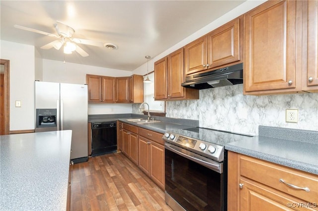 kitchen with sink, dark hardwood / wood-style floors, pendant lighting, stainless steel appliances, and decorative backsplash