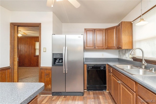 kitchen with stainless steel refrigerator with ice dispenser, sink, black dishwasher, pendant lighting, and ceiling fan