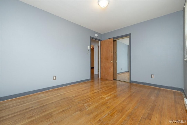 unfurnished bedroom with light hardwood / wood-style floors and a closet