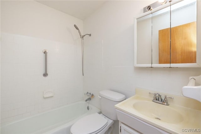 full bathroom with vanity, toilet, tile walls, and tiled shower / bath