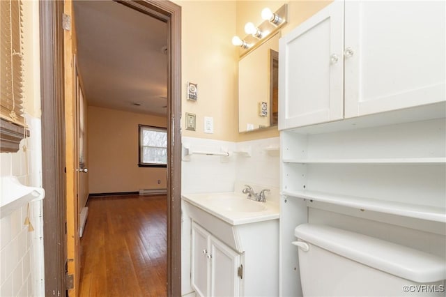 bathroom featuring vanity, hardwood / wood-style flooring, and toilet