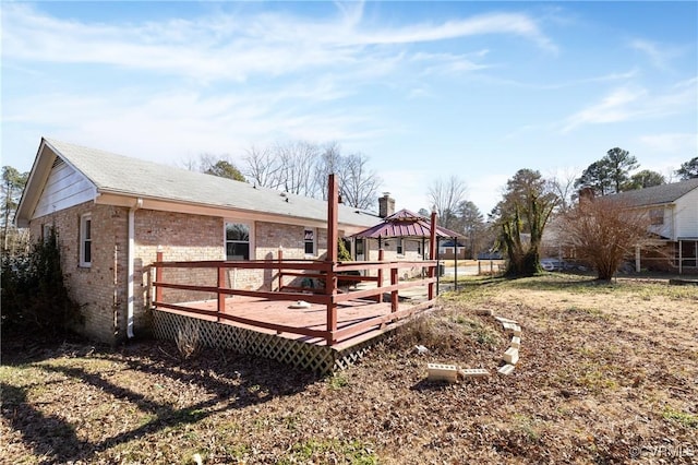 back of house featuring a wooden deck and a gazebo