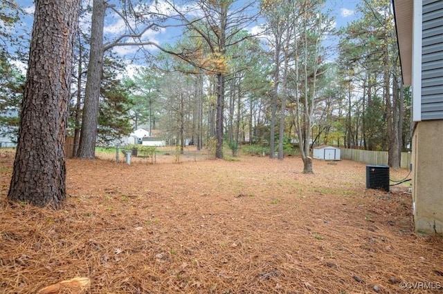 view of yard with central AC unit and a storage unit