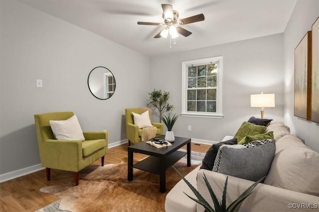 living room featuring ceiling fan and hardwood / wood-style floors