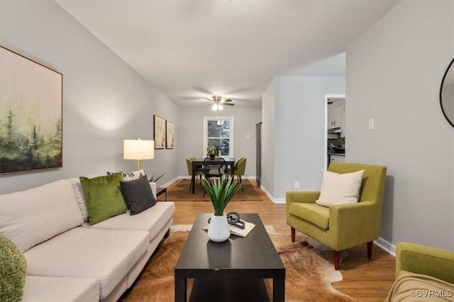 living room with ceiling fan and hardwood / wood-style flooring