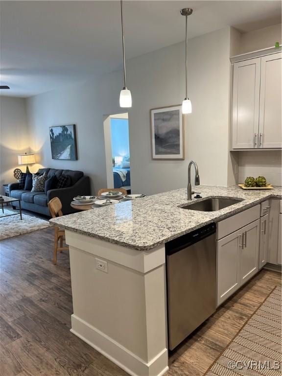 kitchen featuring decorative light fixtures, sink, white cabinets, and dishwasher