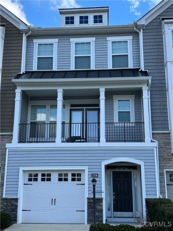 view of front of home with a garage and a balcony