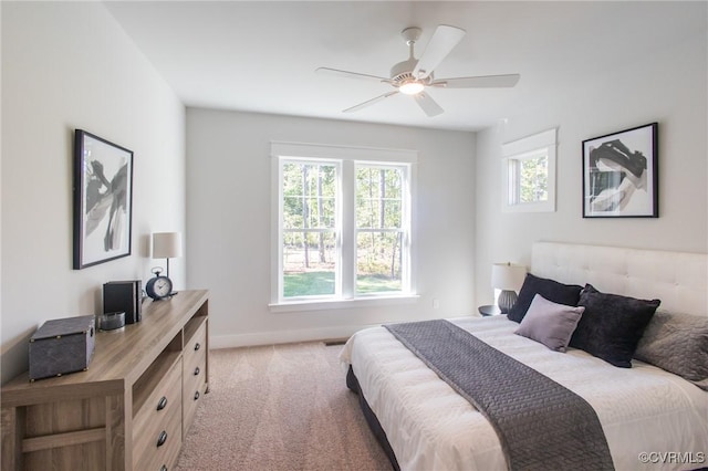 bedroom with light carpet and ceiling fan