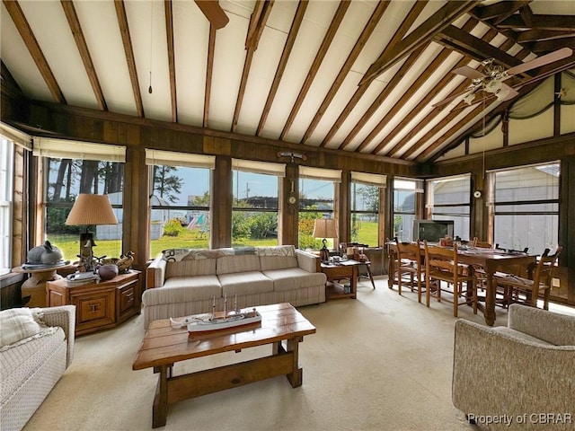 sunroom featuring vaulted ceiling with beams