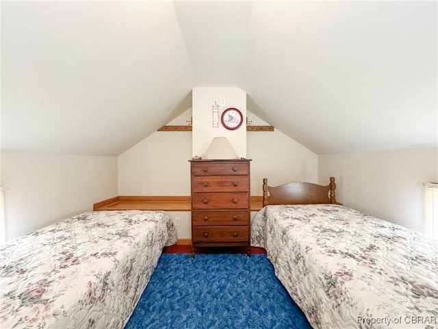 bedroom featuring vaulted ceiling and dark carpet