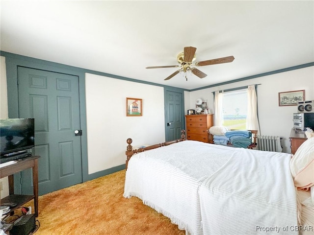 bedroom featuring radiator, ceiling fan, ornamental molding, and light carpet