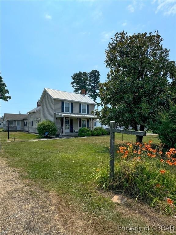 view of front of home with covered porch and a front yard