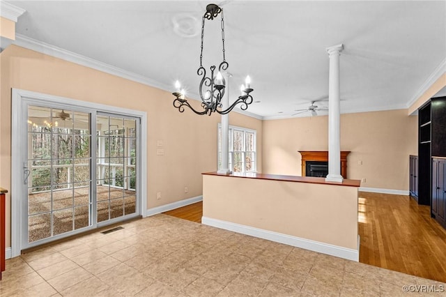 kitchen featuring light tile patterned floors, ceiling fan with notable chandelier, ornamental molding, and pendant lighting